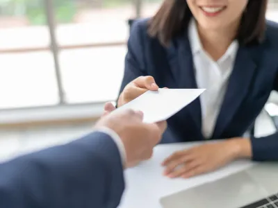 Two people signing documents