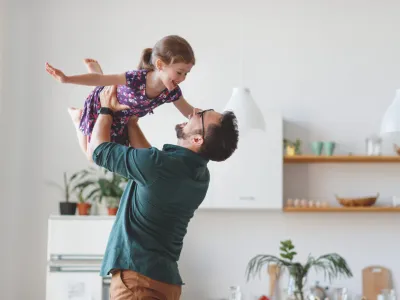 Father lifiting daughter in the air joyfully